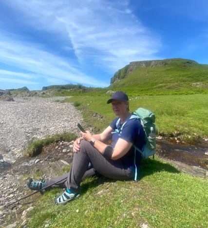 Julie hiking on Kerrera Island, Scottish Highlands - taking a break to catch up on her Twitter feed ;-)