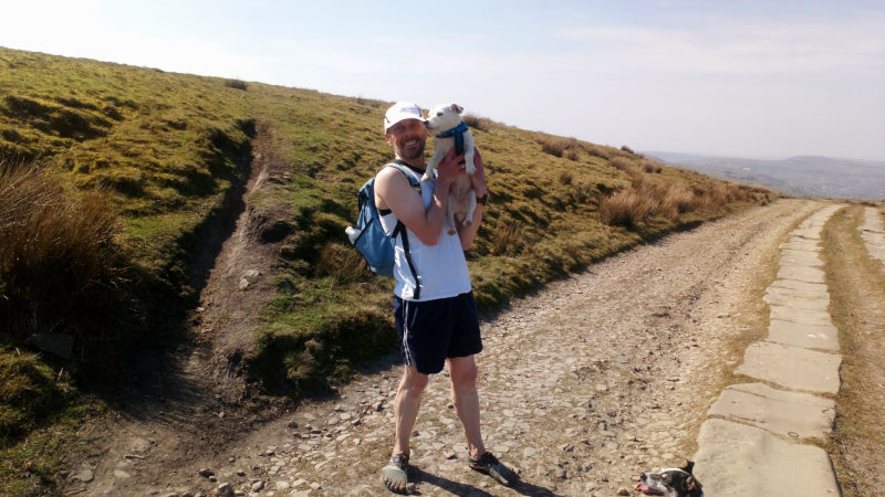 Me running with Molly and Charlie through Lee Quarry, with Charlie peeking up from the bottom-right corner.